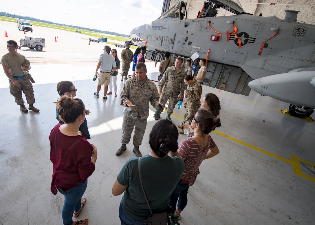 Lt. Col. Mike Perez, 23d Aircraft Maintenance Squadron (AMXS) commander, center, speaks with Team Moody spouses and family members Aug. 23, 2019, at Moody Air Force Base, Ga. Spouses and family members from the 23d AMXS toured the squadron and flightline to gain a first-hand understanding of what role their significant other plays in the mission. The tour also served as a way to expand support networks by connecting spouses and family members with unit personnel. (U.S. Air Force photo by Airman 1st Class Eugene Oliver)