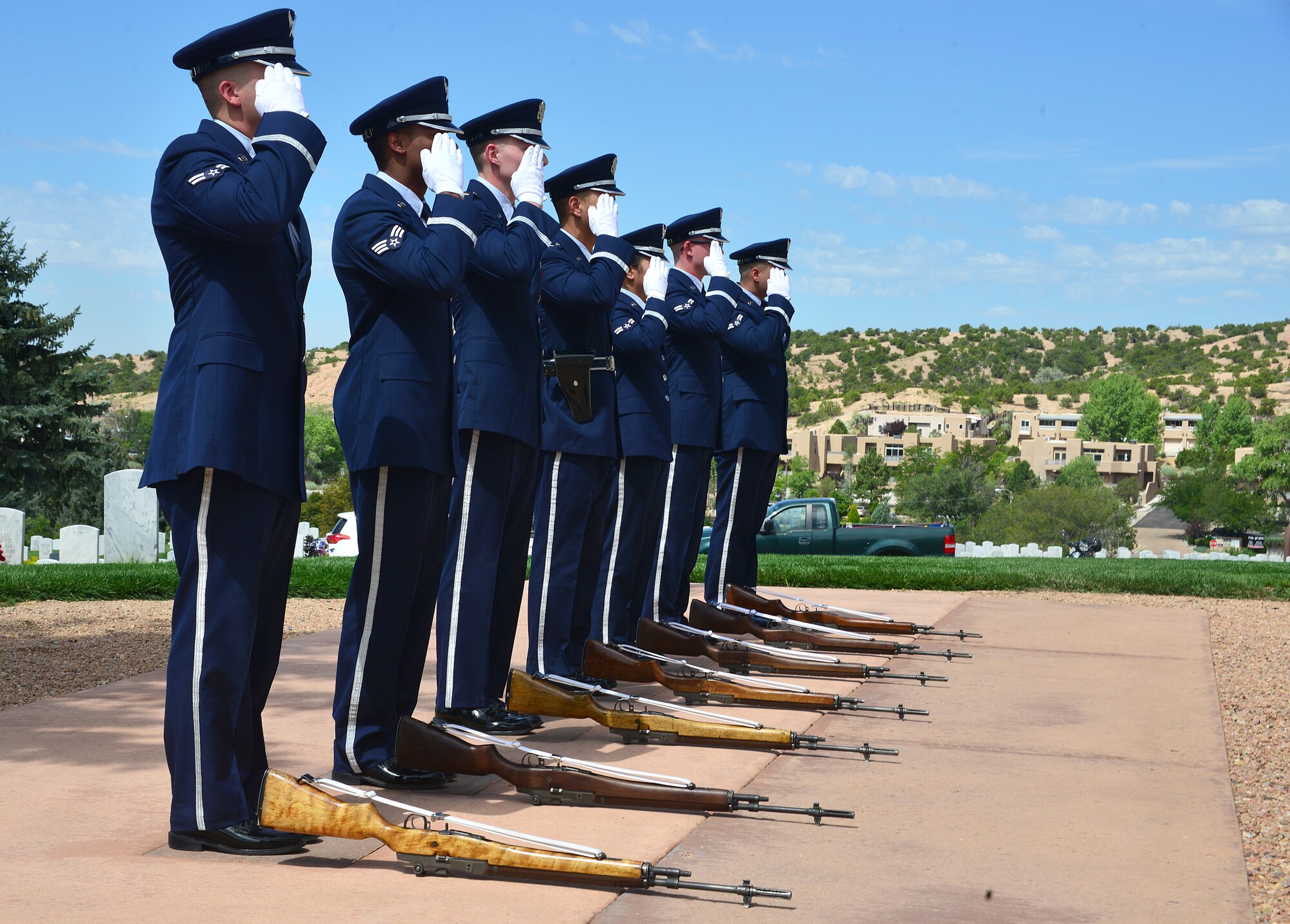Members of the Kirtland Air Force Base Honor Guard salute the remains of U.S. Navy Fireman First Class Billy James Johnson at the Santa Fe National Cemetery in Santa Fe, N.M. Aug. 19, 2019. Johnson was amongst 429 crewmembers of the USS Oklahoma who lost their lives when the battleship came under surprise attack and completely sunk at Pearl Harbor Dec. 7, 1941. (U.S. Air Force photo by Airman 1st Class Austin J. Prisbrey)