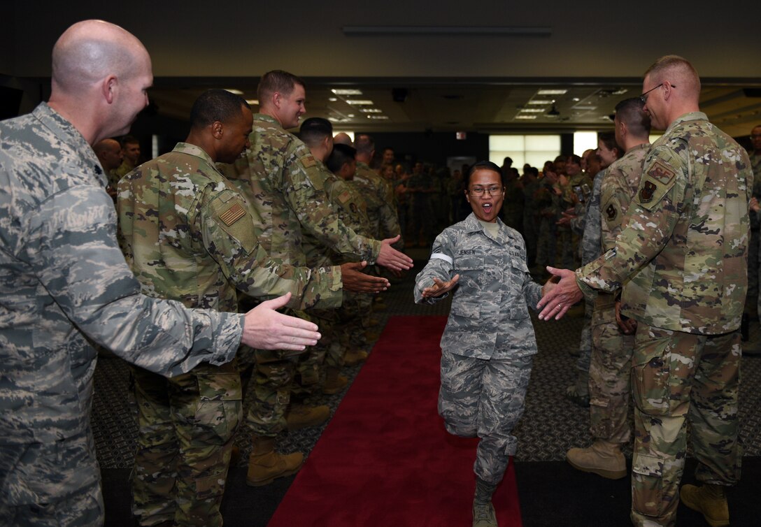 U.S. Air Force Staff Sgt. select Cleofe Jensen, 17th Force Support Squadron career development technician, runs down the gauntlet receiving high-fives during the staff sergeant release party at the event center on Goodfellow Air Force Base, Texas, August 23, 2019. The primary focus of the noncommissioned officer tier of the enlisted force structure is to continue occupational growth and to develop themselves and their troops while accomplishing the mission. (U.S. Air Force photo by Airman 1st Class Robyn Hunsinger/Released)