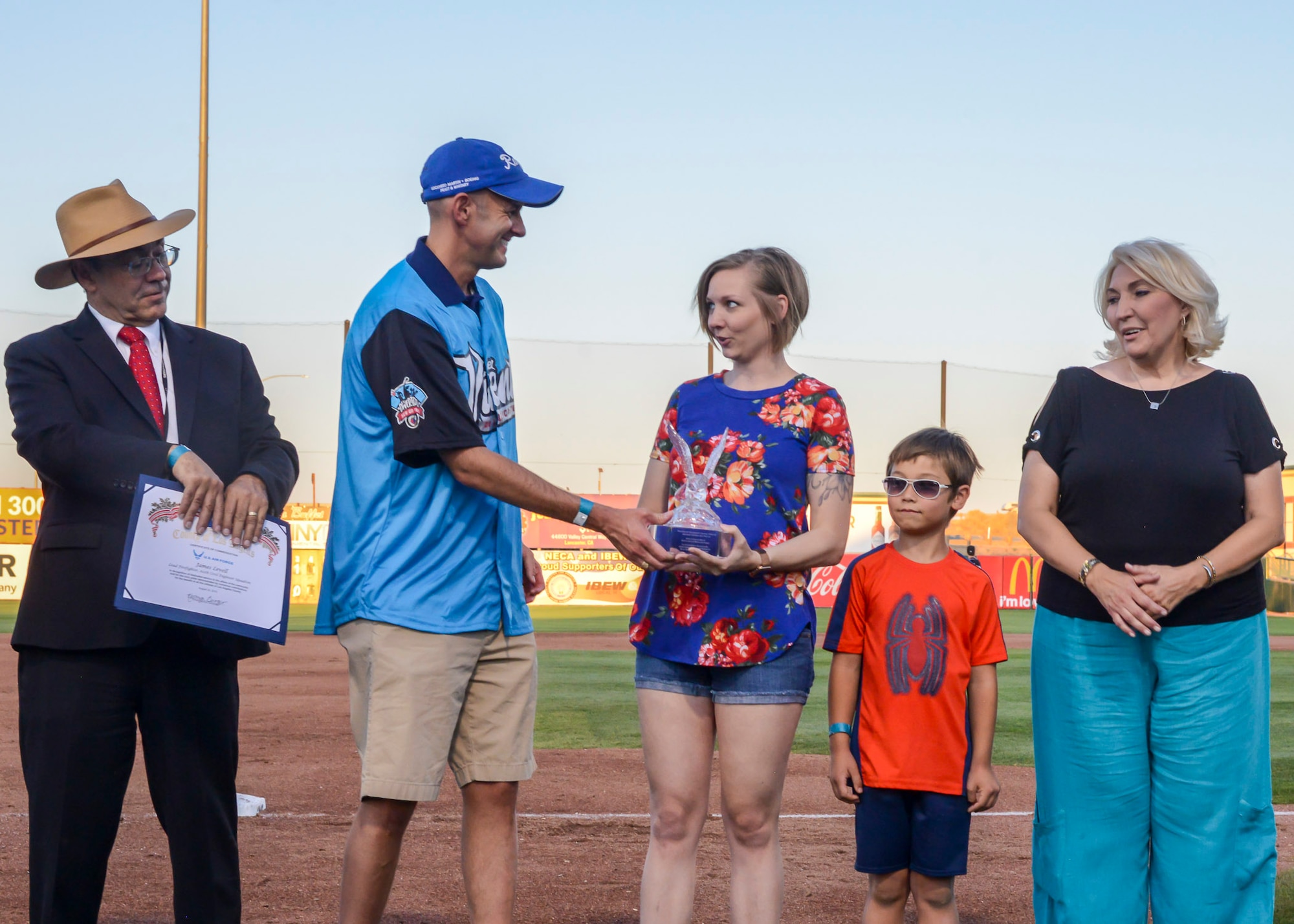 Tech. Sgt. Janna Ybarra, 412th Medical Group, receives the Bank of America/Merrill Military Service Before Self Award during a Lancaster JetHawks game at the Hangar baseball stadium in Lancaster, California, Aug. 24. (U.S. Air Force photo by Giancarlo Casem)