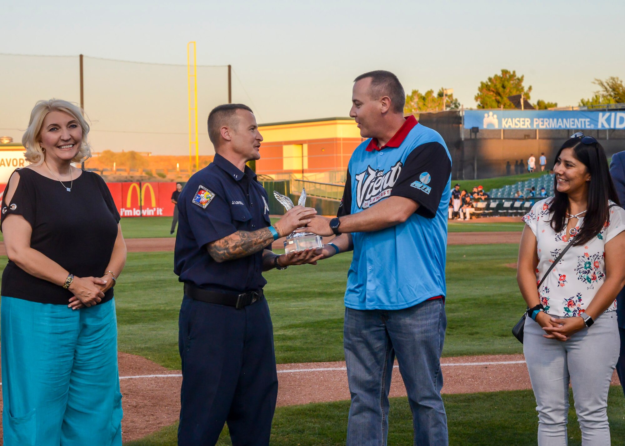 Lead Firefighter James Levell, 812th Civil Engineer Squadron, receives the Bank of America/Merrill Military Service Before Self Award during a Lancaster JetHawks game at the Hangar baseball stadium in Lancaster, California, Aug. 24. (U.S. Air Force photo by Giancarlo Casem)