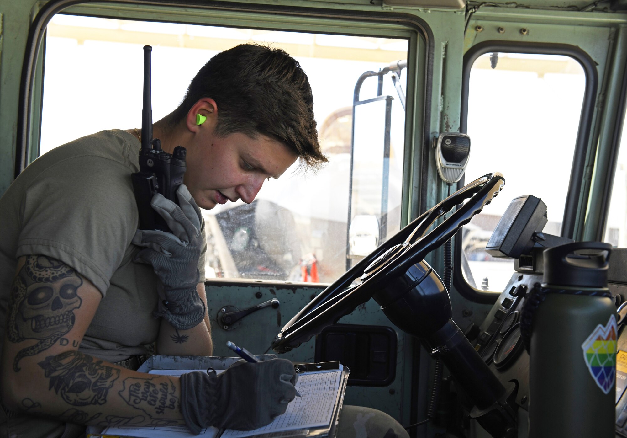 Airman 1st Class Katlynn Masnyk, 56th Logistics Readiness Squadron distribution fuels operator, sits in a R-11 Refueler and relays information over a radio while writing down statistics on a daily summary worksheet after refueling an F-35A Lightning II Aug. 21, 2019, at Luke Air Force Base, Ariz.