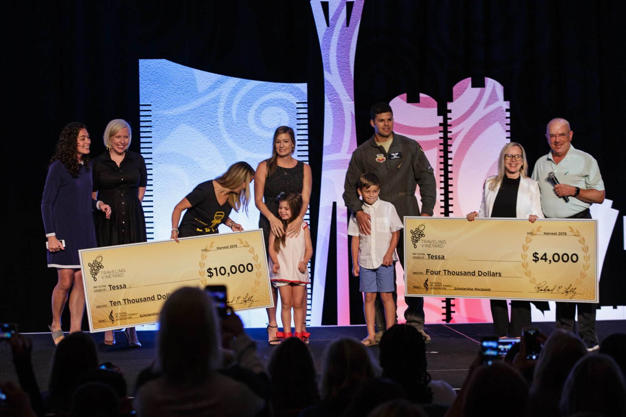 Tessa, key spouse for the 42nd Attack Squadron, receives checks covering her Master’s Degree in Caesar’s Palace, at Las Vegas, Nevada, July 20, 2019.  Tessa teaches second graders at Betsy A. Rhodes Elementary School. (Courtesy photo by: Lindsey Miller)