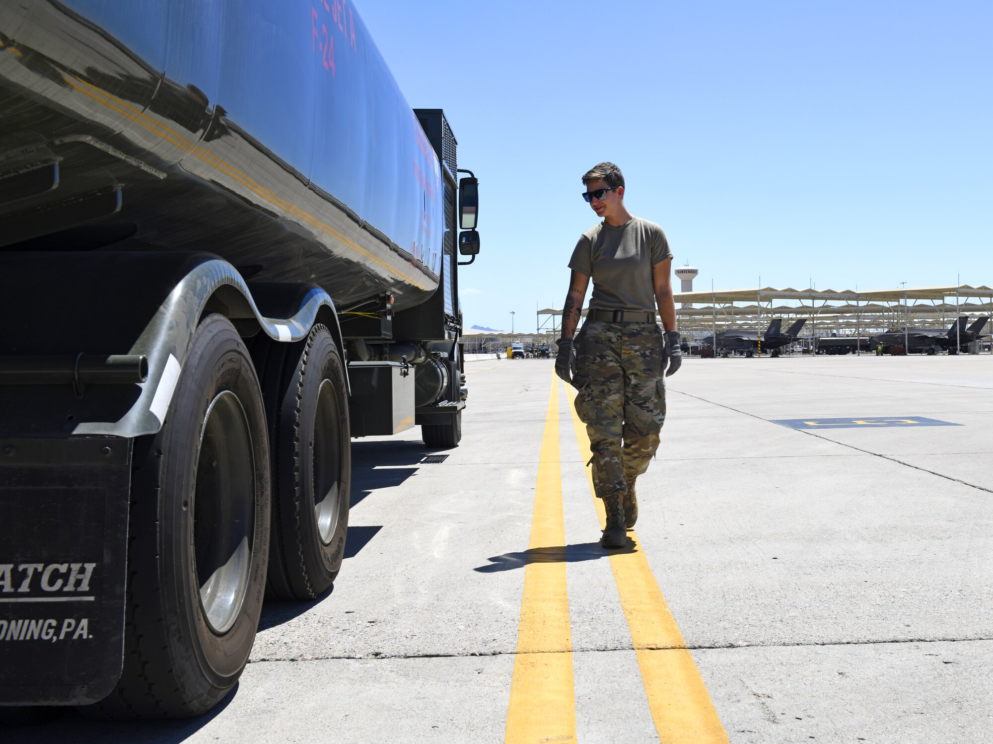 Airman 1st Class Katlynn Masnyk, 56th Logistics Readiness Squadron fuels distribution operator, performs a foreign object debris check Aug. 21, 2019, at Luke Air Force Base, Ariz.