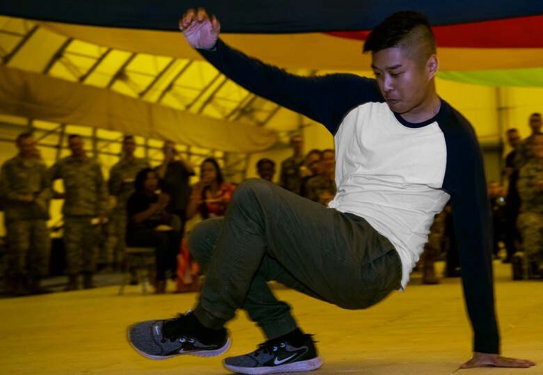 SCHRIEVER AIR FORCE BASE, Colo. – Airman 1st Class Jad Arcega, 50th Force Support Squadron customer service technician, break dances at an annual diversity day event at Schriever Air Force Base, Colorado, Aug. 23, 2019. Arcega is Filipino and said he is proud to represent his culture in the Air Force. (U.S. Air Force photo by Airman 1st Class Jonathan Whitely)