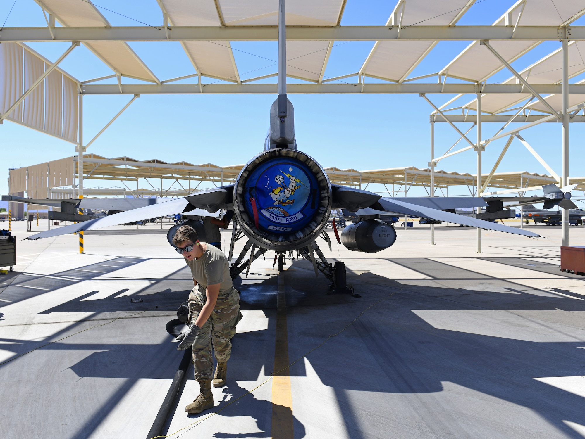 Airman 1st Class Katlynn Masnyk, 56th Logistics Readiness Squadron distribution fuels operator, drags a hose after she finishes refueling an F-16 Fighting Falcon from the 309th Fighter Squadron Aug. 21, 2019, at Luke Air Force Base, Ariz.