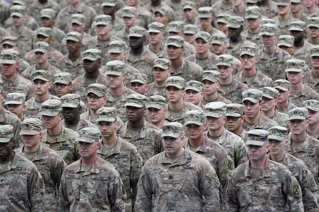 A formation of soldiers standing in rows fills the frame of the photo.