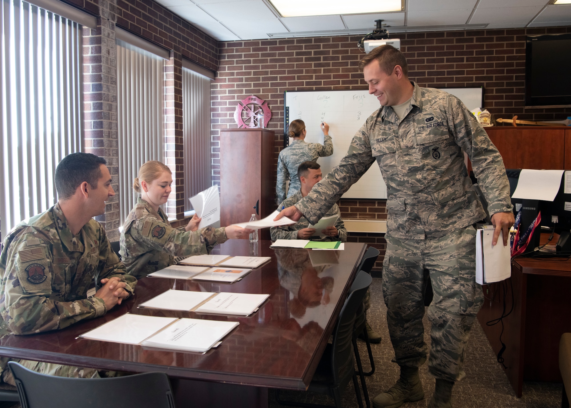 Senior Airman John Gillen, 50th Security Forces Squadron defender and current Airman Leadership School student, hands a clue to ALS instructors during an educational game called Joint Warfighter Amazing Race Aug. 9, 2019 at Peterson Air Force Base, Colorado. Enlisted developmental special duties like ALS instructor offer unique leadership roles and give Airmen the opportunity to mentor and mold future leaders. (U.S. Air Force photo by Heather Heiney)