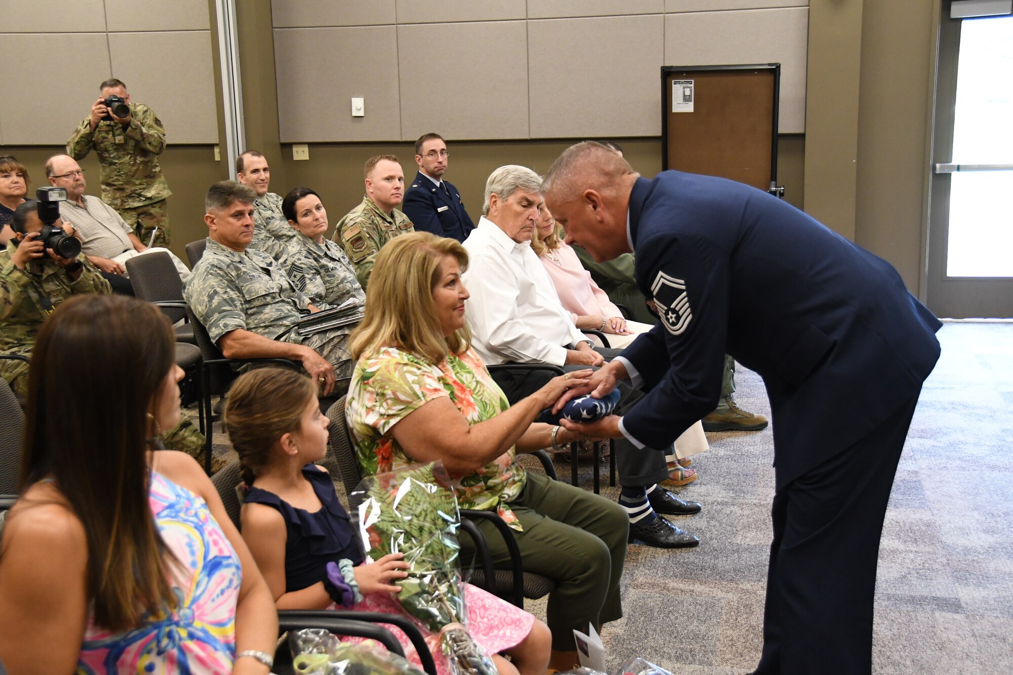 Senior Master Sgt. William Bassett retired from the 932nd Airlift Wing in a ceremony held August 4, 2019 at Scott Air Force Base, Ill.  He was presented the American flag which he presented to his family,  He took a few moments to thank everyone, looked at a list of all the generals he's served under, and touched on the legacy of the 932nd Airlift Wing that he's been a part of since 2005. "Always dream big, and always be a good mentor. It means something. There are so many friends you meet along the way, but they have no idea how much they impacted your life, and you can impact someone's life too," Bassett said. (U.S. Air Force photo by Lt. Col. Stan Paregien)
