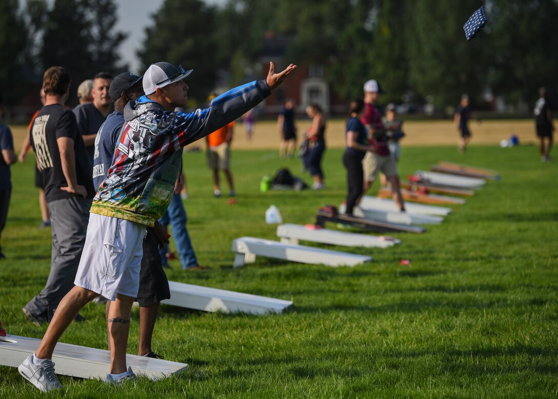 Senior Master Sgt. Kevin Werlein, 90th Security Forces Squadron operations superintendent, tosses a bag in a game of corn hole on Aug. 23, 2019, during the annual Frontiercade on F.E. Warren Air Force Base, Wyo. Each Squadron competed in sports and games for a first place trophy. (U.S. Air Force photo by Staff Sgt. Ashley N. Sokolov)