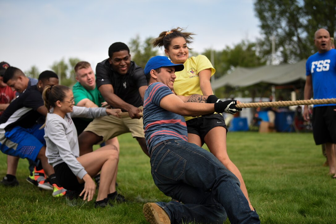 A team of Airmen pull in a tug-of-war match Aug. 23, 2019, during the annual Frontiercade on F.E. Warren Air Force Base, Wyo. Every year, 90th Force Support Squadron hosts a picnic and squadron sports competition for Airmen and families on base. (U.S. Air Force photo by Staff Sgt. Ashley N. Sokolov)