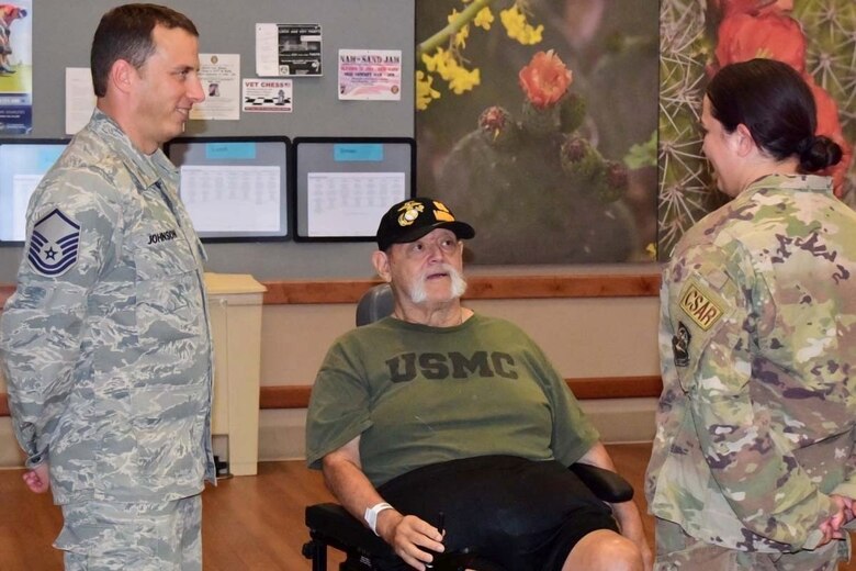 Airmen visit with Marine Veteran at Tucson Veteran's Administration Hospital