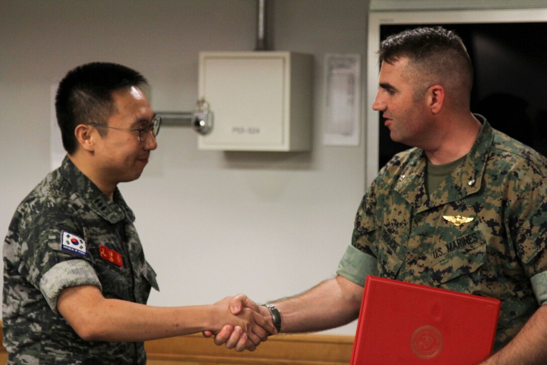 U.S. Marine Corps Forces Korea (MARFORK) honors Captain Ko Hyun Jong for serving as the Republic of Korea Marine Corps Liaison Officer to MARFORK Aug. 26. Capt. Ko plays a critical role in assisting MARFORK during operations by serving as a vital link between two staffs from two separate nations. Liaison Officers from both the U.S. Marine Corps and ROK Marine Corps continue the tradition of brotherhood between the two services and build upon the ROK-US Alliance that has stood for over 70 years. (U.S. Marine Corps Photo by Sgt. Paker Golz)