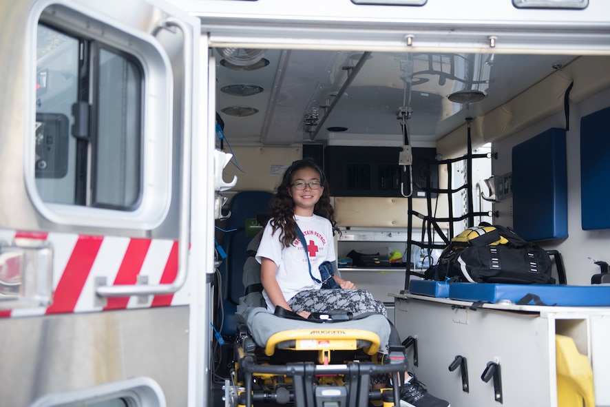 A young girl sits in an ambulance August 17, 2019, on Mountain Home Air Force Base, Idaho. The ambulance was parked in front of the Medical Training Facility where Airmen and families could see the equipment used by first responders. (U.S. Air Force photo by Airman Natalie Rubenak)