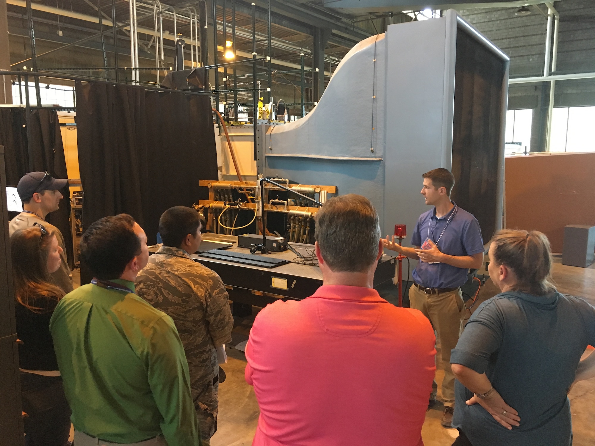AFRL Aerospace Systems Directorate Aerospace Engineer Chris Marks explains the low speed cascade wind tunnel during the Aug. 19, 2019, Open House. This facility is used to gather data that impacts the efficiency, size, weight, and cost of future Air Force engines. (U.S. Air Force photo/Tim Bergeron)