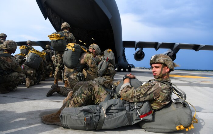 A paratrooper assigned to the 82nd Airborne Division takes a rest before boarding a Joint Base Charleston C-17 Globemaster III while performing a parachute assault exercise during Battalion Mobility Tactical Week at Fort Bragg, N.C., Aug. 19, 2019. Battalion Mass Tactical Week is a joint exercise involving the U.S. Air Force and the U.S. Army designed to enhance service members’ abilities by practicing contingency operations in a controlled environment. The exercise incorporated three C-130J Super Hercules assigned to Little Rock Air Force Base, Arkansas, three C-17 Globemaster IIIs assigned to Joint Base Charleston, S.C. and Army paratroopers assigned to the 82nd Airborne Division of Fort Bragg, N.C. The exercise allowed all parties to quickly and safely complete training tasks, such as personnel and cargo air drops, to prepare joint forces to operate during global mobility missions.