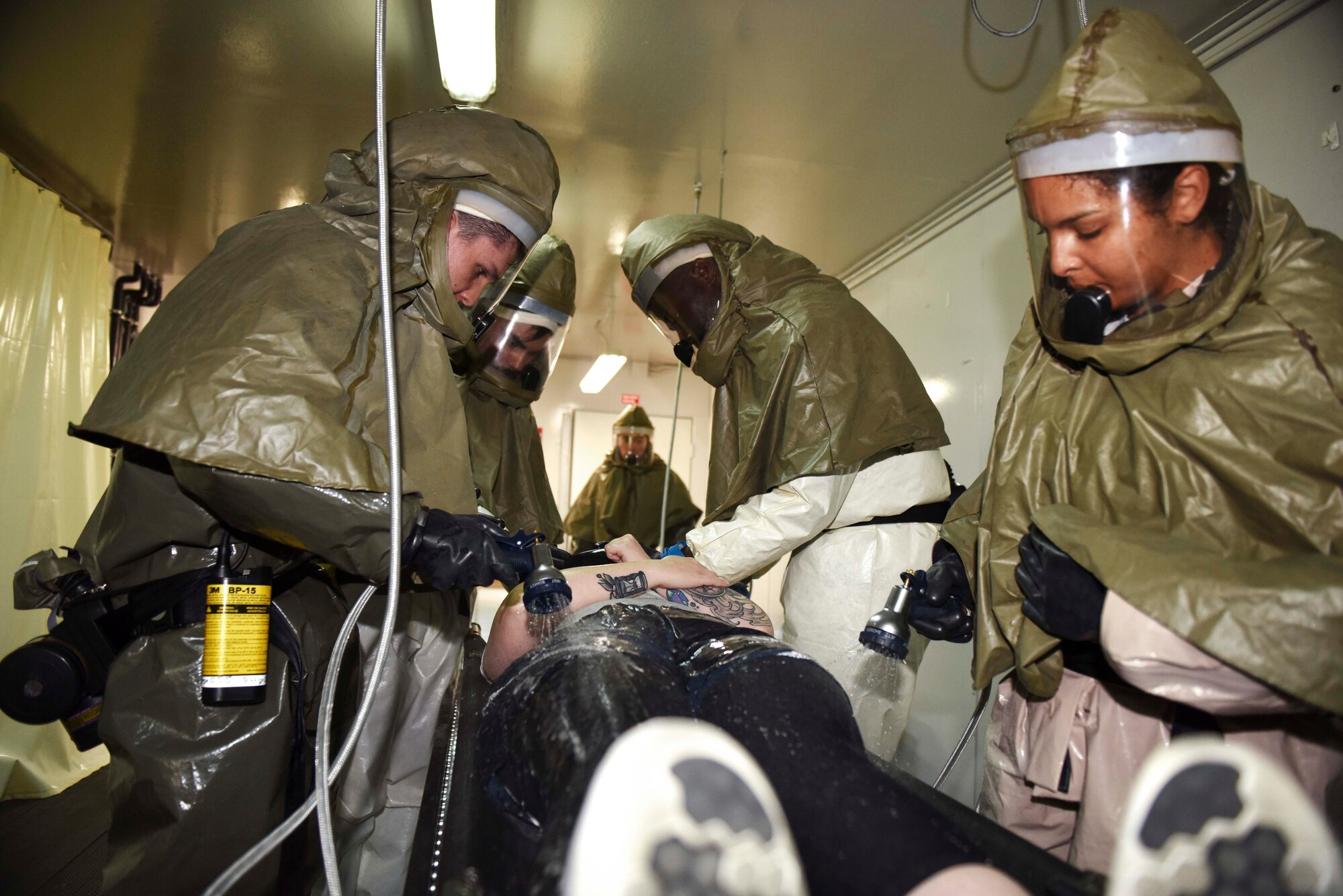 Airmen assigned to the 39th Medical Group wash a simulated contamination victim during an exercise Aug. 21, 2019, at Incirlik Air Base, Turkey. The exercise involved numerous scenarios designed to test the reactions of Airmen to different emergencies and assess their ability to respond. (U.S. Air Force photo by Staff Sgt. Joshua Magbanua)