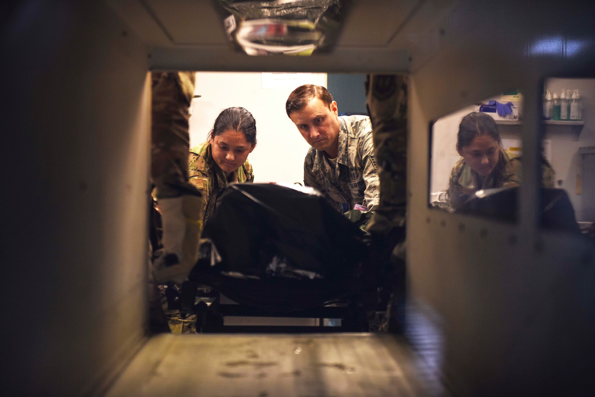 Airmen assigned to the 39th Medical Group remove a simulated contamination victim from a compartment during an exercise Aug. 21, 2019, at Incirlik Air Base, Turkey. 39th MDG personnel follow strict procedures during emergencies in order to prevent the spread of communicable hazards. (U.S. Air Force photo by Staff Sgt. Joshua Magbanua)