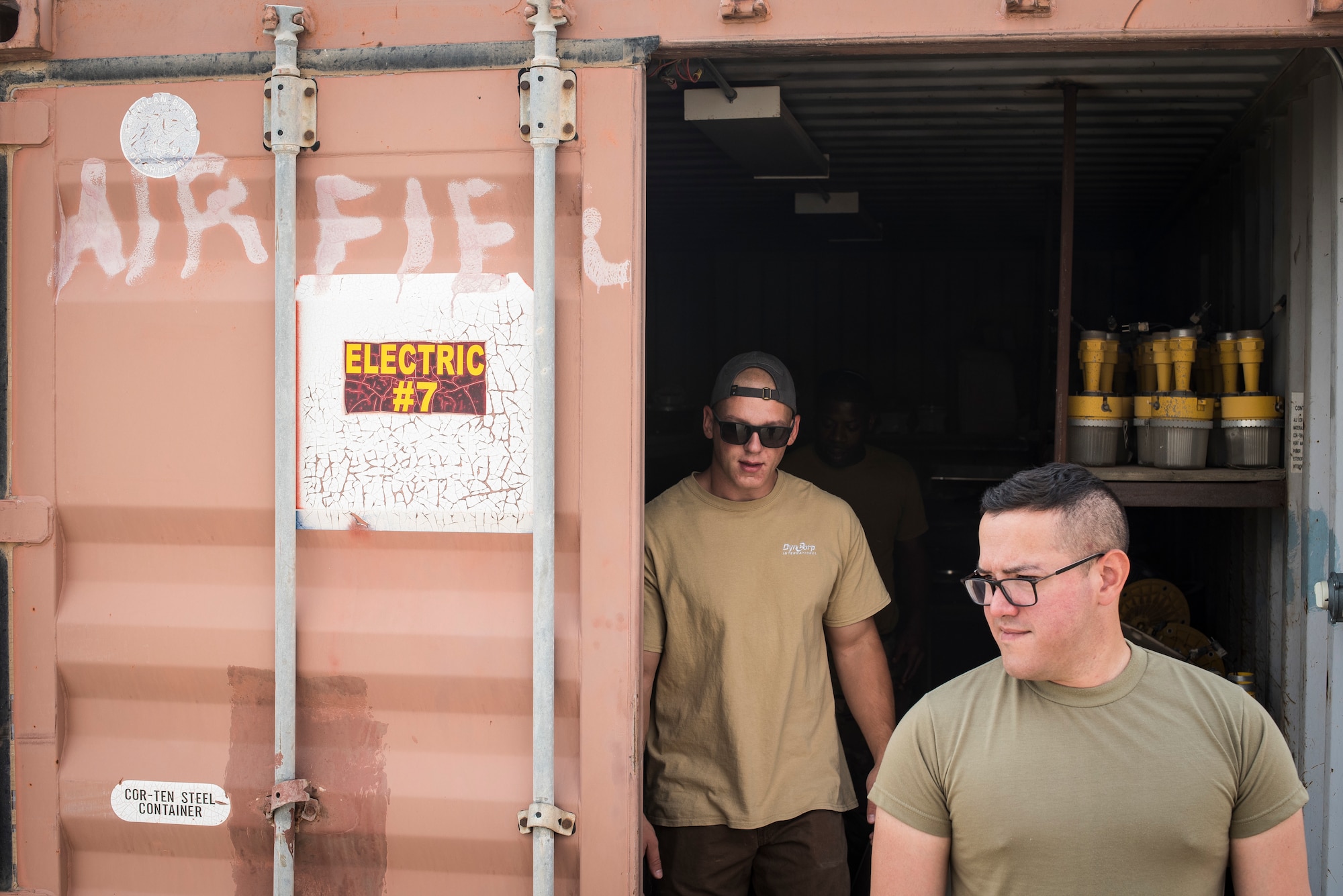 Staff Sgt. Raul Cancel, 386th Expeditionary Civil Engineer Squadron electrical systems craftsman, and a contractor retrieve inventory items at Ali-Al Salem Air Base, Kuwait, Aug. 14, 2019. After identifying issues with the lighting on the flightline, Cancel and his shop stocked up on items before setting out to the work sites. (U.S. Air Force photo by Senior Airman Lane T. Plummer)