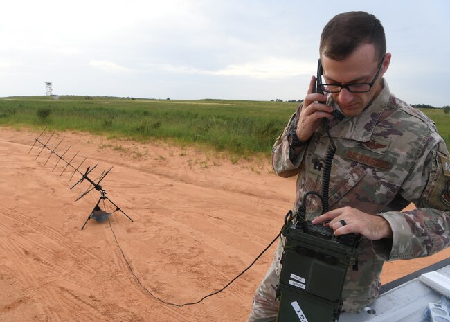 U.S. Air Force Capt. Peter Callo, an air mobility liaison officer assigned to the 621st Mobility Support Operations Squadron from Joint Base McGuire-Dix-Lakehurst, N.J., inspects communications equipment during Battalion Mobility Tactical Week at Fort Bragg, N.C., Aug. 20, 2019. Battalion Mass Tactical Week is a joint exercise involving the U.S. Air Force and the U.S. Army designed to enhance service members’ abilities by practicing contingency operations in a controlled environment. The exercise incorporated three C-130J Super Hercules assigned to Little Rock Air Force Base, Arkansas, three C-17 Globemaster IIIs assigned to Joint Base Charleston, S.C. and Army paratroopers assigned to the 82nd Airborne Division of Fort Bragg, N.C. The exercise allowed all parties to quickly and safely complete training tasks, such as personnel and cargo air drops, to prepare joint forces to operate during global mobility missions.