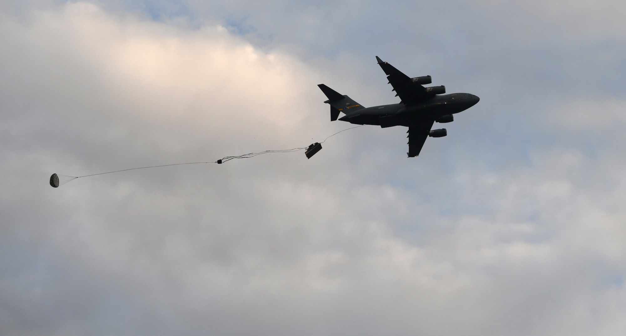 A Joint Base Charleston C-17 Globemaster III airdrops equipment onto a landing zone during Battalion Mobility Tactical Week at Fort Bragg, N.C., Aug. 20, 2019. Battalion Mass Tactical Week is a joint exercise involving the U.S. Air Force and the U.S. Army designed to enhance service members’ abilities by practicing contingency operations in a controlled environment. The exercise incorporated three C-130J Super Hercules assigned to Little Rock Air Force Base, Arkansas, three C-17 Globemaster IIIs assigned to Joint Base Charleston, S.C. and Army paratroopers assigned to the 82nd Airborne Division of Fort Bragg, N.C. The exercise allowed all parties to quickly and safely complete training tasks, such as personnel and cargo air drops, to prepare joint forces to operate during global mobility missions.