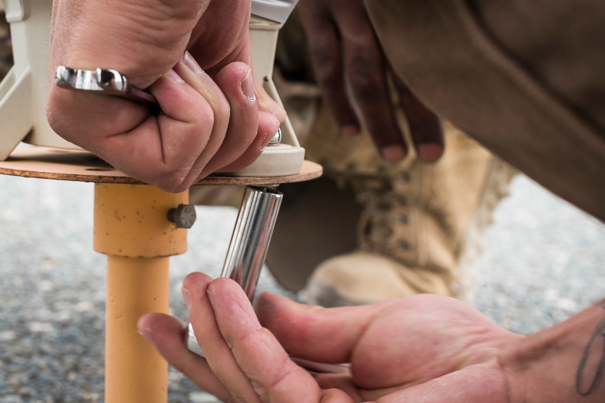 A contractor with the 386th Expeditionary Civil Engineer Squadron replaces a solar-powered taxiway light at Ali-Al Salem Air Base, Kuwait, Aug. 14, 2019. The mission for all civil engineer Airmen is to ensure buildings and facilities continue to run effectively and maintain combat-readiness. (U.S. Air Force photo by Senior Airman Lane T. Plummer)