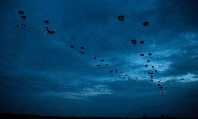 Joint Base Charleston C-17 Globemaster IIIs and C-130J Super Hercules assigned to Little Rock Air Force Base airdrop paratroopers onto a landing zone at lowlight conditions during Battalion Mobility Tactical Week at Fort Bragg, N.C., Aug. 20, 2019. Battalion Mass Tactical Week is a joint exercise involving the U.S. Air Force and the U.S. Army designed to enhance service members’ abilities by practicing contingency operations in a controlled environment. The exercise incorporated three C-130J Super Hercules assigned to Little Rock Air Force Base, Arkansas, three C-17 Globemaster IIIs assigned to Joint Base Charleston, S.C. and Army paratroopers assigned to the 82nd Airborne Division of Fort Bragg, N.C. The exercise allowed all parties to quickly and safely complete training tasks, such as personnel and cargo air drops, to prepare joint forces to operate during global mobility missions.