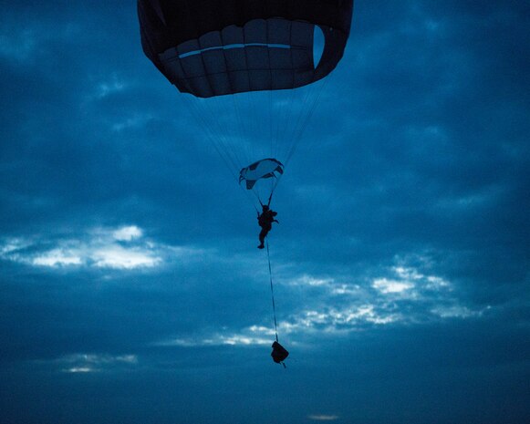 A paratrooper assigned to the 82nd Airborne Division descends onto a landing zone at lowlight conditions during Battalion Mobility Tactical Week at Fort Bragg, N.C., Aug. 20, 2019. Battalion Mass Tactical Week is a joint exercise involving the U.S. Air Force and the U.S. Army designed to enhance service members’ abilities by practicing contingency operations in a controlled environment. The exercise incorporated three C-130J Super Hercules assigned to Little Rock Air Force Base, Arkansas, three C-17 Globemaster IIIs assigned to Joint Base Charleston, S.C. and Army paratroopers assigned to the 82nd Airborne Division of Fort Bragg, N.C. The exercise allowed all parties to quickly and safely complete training tasks, such as personnel and cargo air drops, to prepare joint forces to operate during global mobility missions.