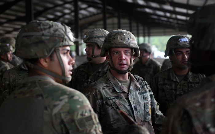 A paratrooper jump master assigned to the 82nd Airborne Division addresses his troops before taking part in fall exercises during Battalion Mobility Tactical Week at Fort Bragg, N.C., Aug. 19, 2019. Battalion Mass Tactical Week is a joint exercise involving the U.S. Air Force and the U.S. Army designed to enhance service members’ abilities by practicing contingency operations in a controlled environment. The exercise incorporated three C-130J Super Hercules assigned to Little Rock Air Force Base, Arkansas, three C-17 Globemaster IIIs assigned to Joint Base Charleston, S.C. and Army paratroopers assigned to the 82nd Airborne Division of Fort Bragg, N.C. The exercise allowed all parties to quickly and safely complete training tasks, such as personnel and cargo air drops, to prepare joint forces to operate during global mobility missions.