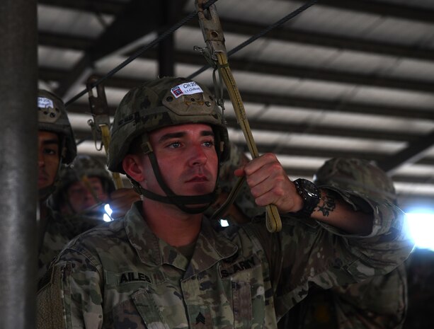 A paratrooper assigned to the 82nd Airborne Division secures their jump line before taking part in fall exercises during Battalion Mobility Tactical Week at Fort Bragg, N.C., Aug. 19, 2019. Battalion Mass Tactical Week is a joint exercise involving the U.S. Air Force and the U.S. Army designed to enhance service members’ abilities by practicing contingency operations in a controlled environment. The exercise incorporated three C-130J Super Hercules assigned to Little Rock Air Force Base, Arkansas, three C-17 Globemaster IIIs assigned to Joint Base Charleston, S.C. and Army paratroopers assigned to the 82nd Airborne Division of Fort Bragg, N.C. The exercise allowed all parties to quickly and safely complete training tasks, such as personnel and cargo air drops, to prepare joint forces to operate during global mobility missions.
