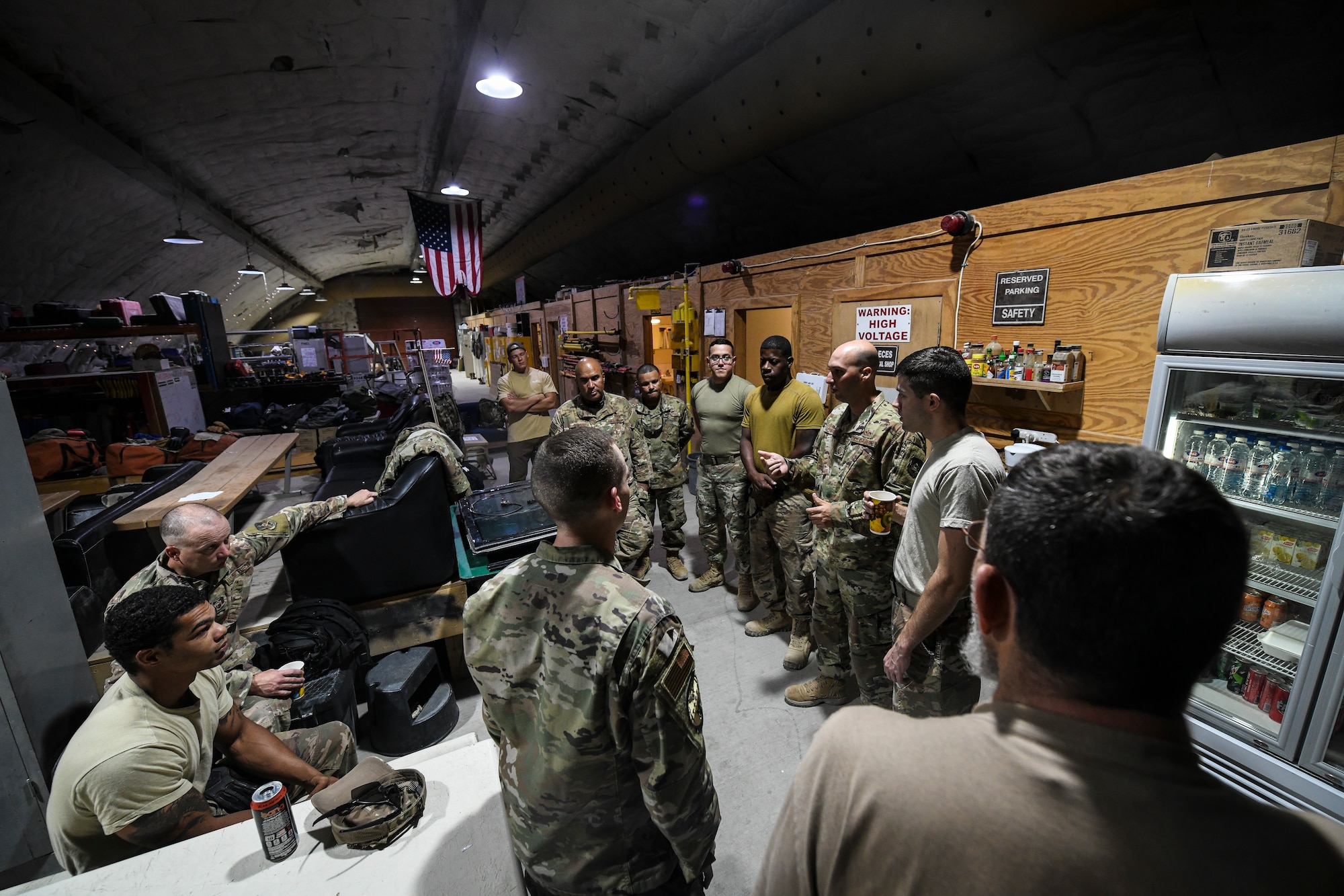 Airmen with the 386th Expeditionary Civil Engineer Squadron hold a group meeting before starting the work day at Ali-Al Salem Air Base, Kuwait, Aug. 13, 2019. The shop uses their group meetings to divide work among the Airmen and set guidelines for the day. (U.S. Air Force photo by Senior Airman Lane T. Plummer)