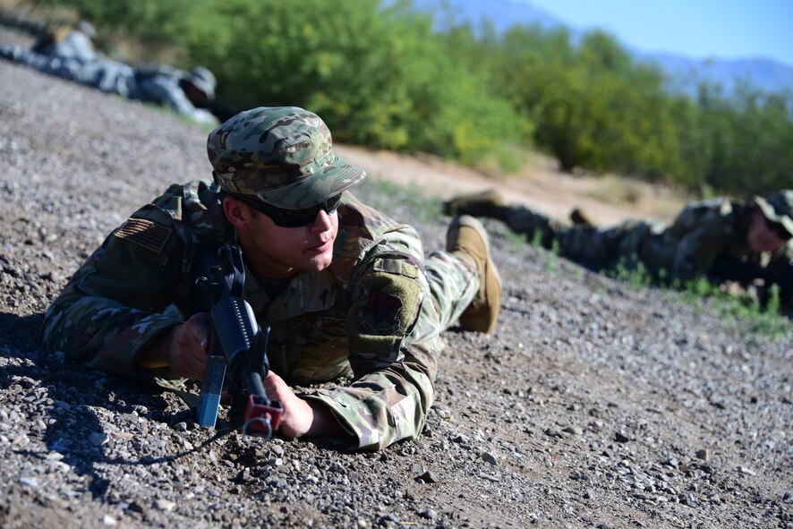 An Airman assigned to the 355th Maintenance Group communicates with teammates during the first Field Expeditionary Combat Skills Training at Davis-Monthan Air Force Base, Arizona, Aug. 20, 2019. The training was held at the 355th Security Forces Squadron training grounds on Davis-Monthan. (U.S. Air Force photo by Airman 1st Class Jacob T. Stephens)