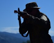a photo of an airman working with a practice M-16