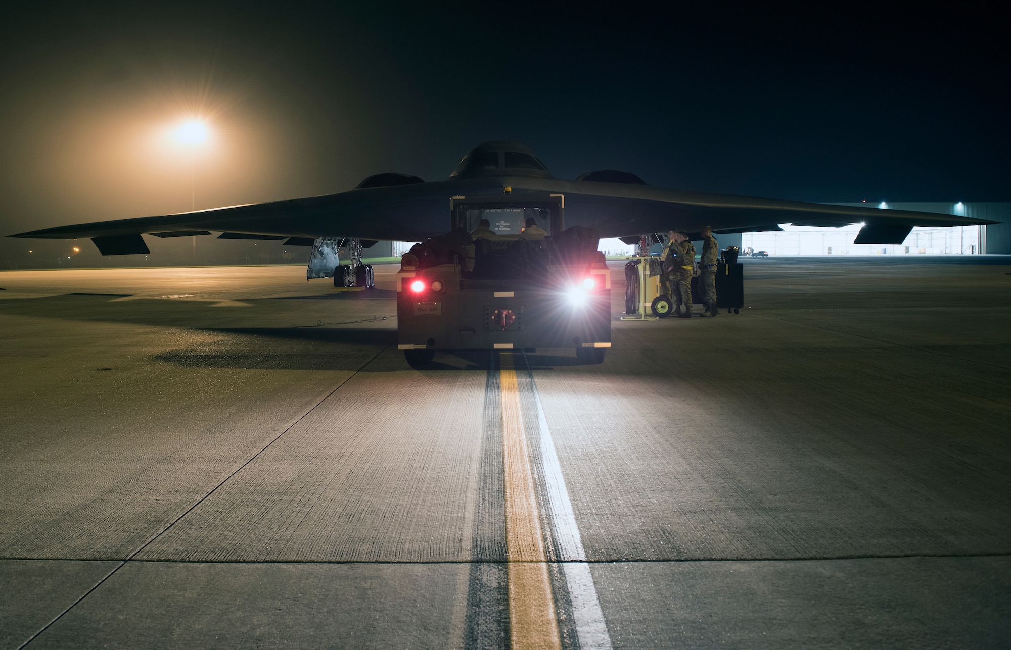 Crew chiefs assigned to the 509th Bomb Wing at Whiteman Air Force Base, Missouri, prepare a B-2 Spirit to be towed into a hangar at Royal Air Base Fairford, England, on Aug. 27, 2019. A Bomber Task Force deployment of B-2 Spirit stealth bomber aircraft, Airmen and support equipment from the 509th Bomb Wing at Whiteman AFB arrived in the U.S. European Command area of operations for a deployment to conduct theater integration and flying training. The deployment of strategic bombers to the United Kingdom helps exercise RAF Fairford as a forward operating base for the unit, ensuring they are engaged, postured and ready with credible force to assure, deter and defend the U.S. and its allies in an increasingly complex security environment. (U.S. Air Force photo by Staff Sgt. Kayla White)