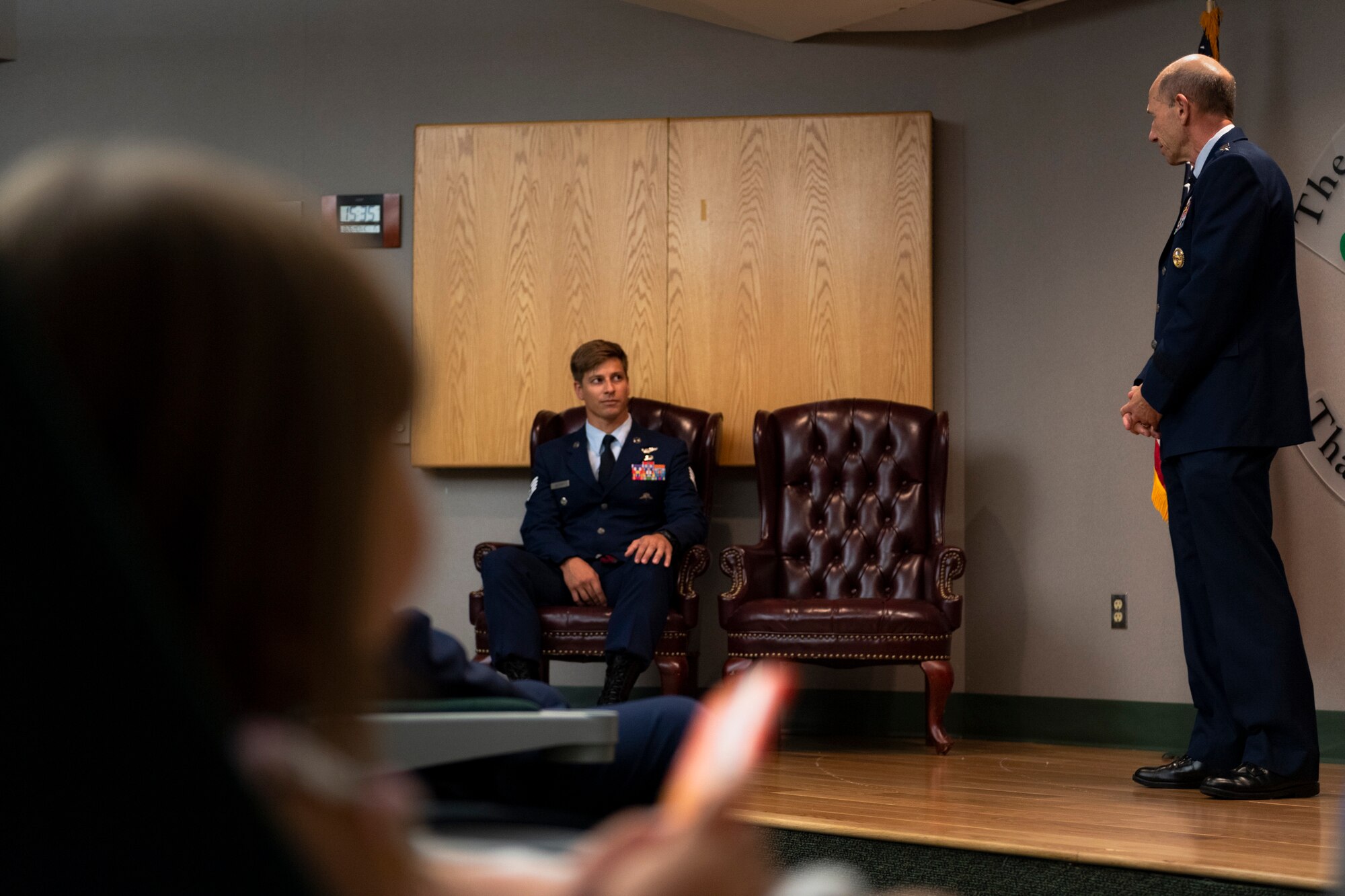 U.S. Air Force Gen. Mike Holmes, right, commander of Air Combat Command, speaks to Staff Sgt. Aaron Metzger, center, 38th Rescue Squadron pararescueman, during a Bronze Star Medal with Valor presentation Aug. 26, 2019, at Moody Air Force Base, Ga. Metzger was awarded the medal because of his engagement in action against an enemy while deployed to Afghanistan in 2018. (U.S. Air Force photo by Airman 1st Class Taryn Butler)