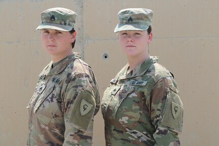 Staff Sgt. Justine Jones, a culinary specialist from Gary, Indiana, proudly stands with her sister, Sgt. Jenna Jones, aviation operations specialist from Gary, Indiana, Aug. 21, 2019. The sisters support Task Force Spartan, building lasting and trusting relationships with regional partners from Camp Arifjan, Kuwait.