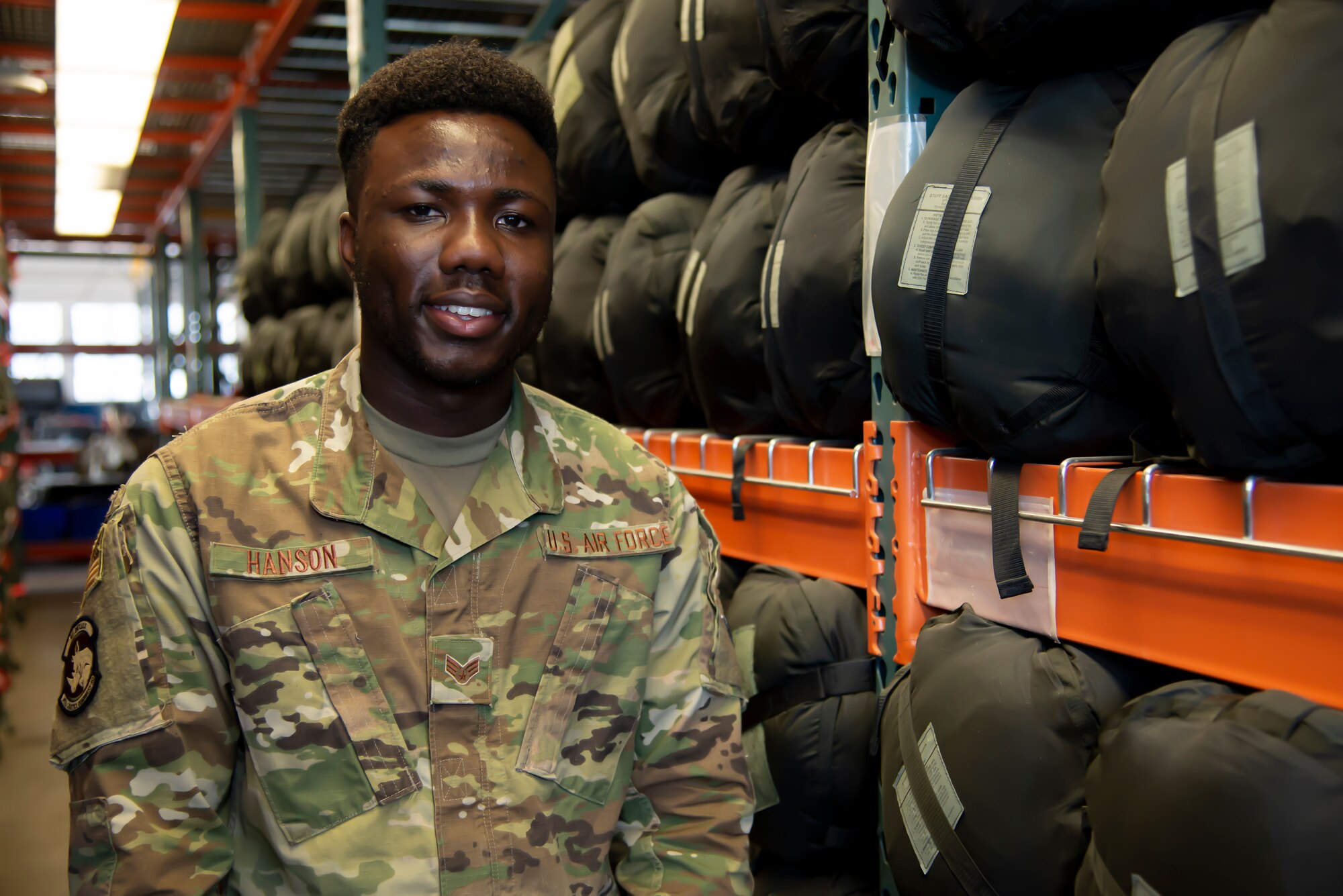 Senior Airman Kobby Hanson, 302nd Logistics Readiness Squadron, stands inside a supply warehouse at Peterson Air Force Base, Colorado, Aug. 23, 2019.