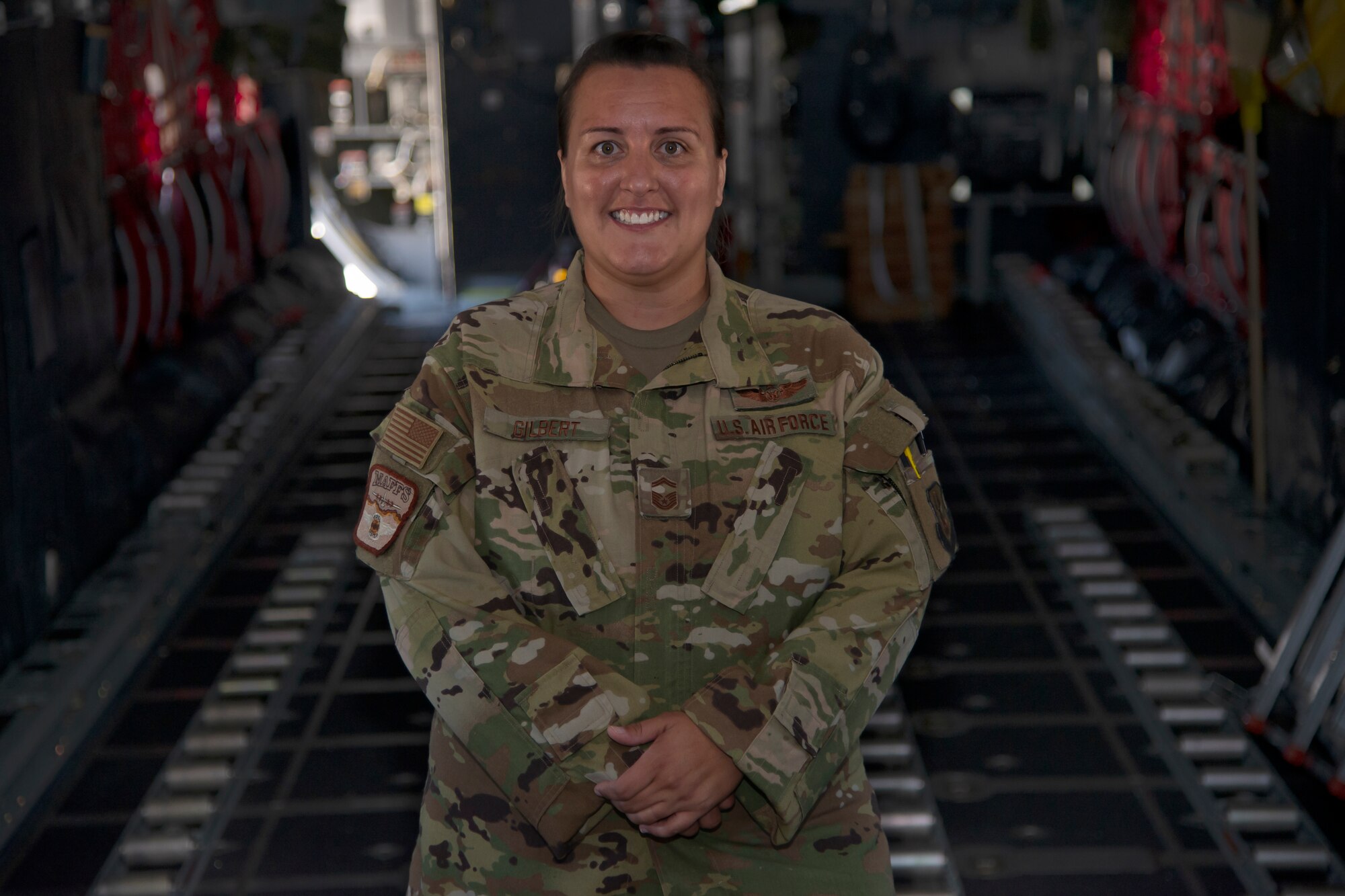 Senior Master Sgt. Nattessa Gilbert, 731st Airlift Squadron, stands inside a C-130 Hercules aircraft Aug. 26, 2019 at Peterson Air Force Base, Colorado