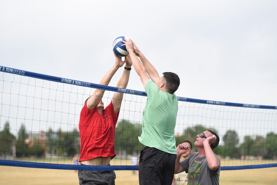 Two squadrons from the 90th Missile Wing go head-to-head in a game of volleyball during the annual Frontiercade event Aug. 23, 2019, at F.E. Warren Air Force Base. Each squadron competed in 12 different activities and were placed into winning or losing brackets to determine an overall first place winner. The sports and games consisted of corn hole, soccer, ultimate frisbee, and even a hotdog eating competition.  (U.S. Air Force photo by Senior Airman Nicole Reed)