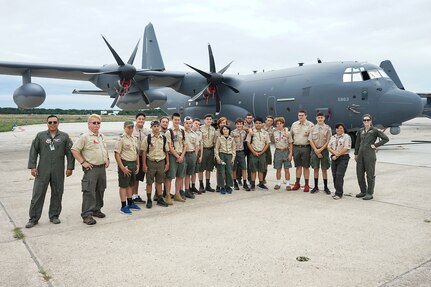 Members of Scout Troop 161, out of Shoreham, N.Y., pose with members of the 106th Rescue Wing, in front of an HC-130J Combat King II at Francis S. Gabreski Air National Guard Base, Westhampton Beach, N.Y., Aug. 23, 2019. The Scouts were invited on a base tour as a show of support after an alleged drunk driver killed one and injured four of their troop last September.