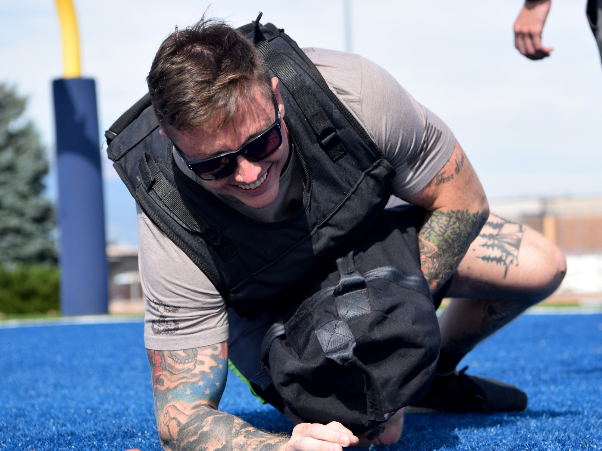 The 21st Civil Engineering Squadron's Explosive Ordnance Disposal team members like Staff Sgt. Lawrence Gress, 21st CES EOD team member, pictured Aug. 23, 2019, train by doing “The Gruester.” The Gruester is an exercise that involves sprinting, rolling and pushups with a 30-pound vest and a 50-pound bag. Gress compared the group's constant, rigorous training to playing team sports. That’s what he says it takes to stay proficient and effective for when the group is called out to address a potential explosive threat. (U.S. Air Force photo by Griffin Swartzell)