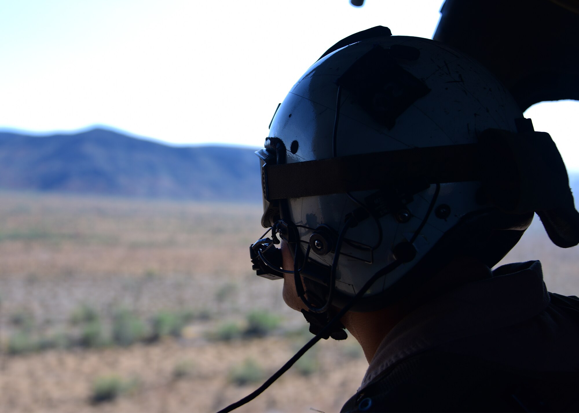 a photo of a Navy sailor sitting in a ahelicopter