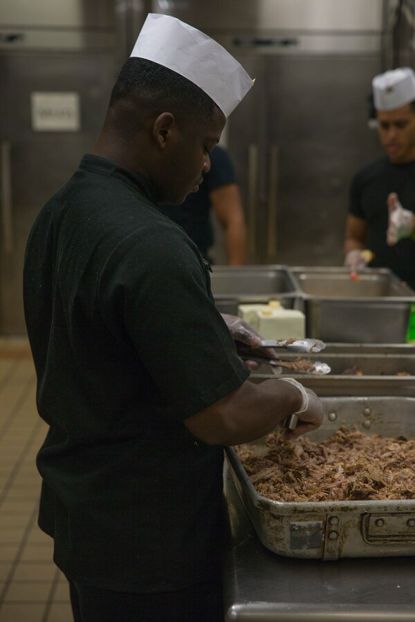 U.S. Marine Corps Lance Cpl. Jeremiah Truss, a food service specialist assigned to Headquarters and Headquarters Squadron, prepares his meal for a Chef of the Quarter competition at Marine Corps Air Station Cherry Point, North Carolina, Aug. 23, 2019. During Chef of the Quarter, contestants battled it out for a spot in Chef of the Year. The contestants faced off against each other to get the top vote from a panel of judges who graded them on the taste, plating and overall presentation of their food. (U.S. Marine Corps photo by Lance Cpl. Jacob Bertram)