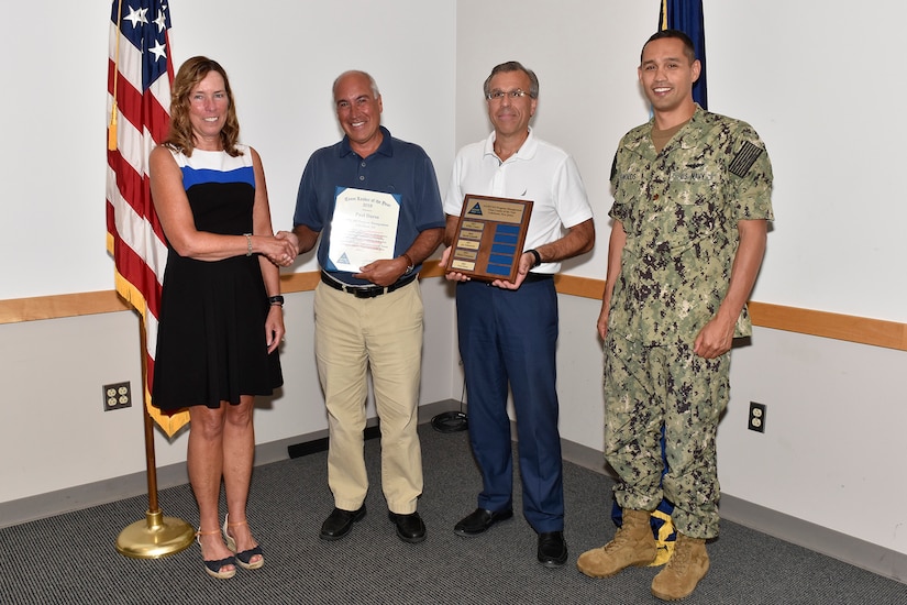 NAWCAD Lakehurst Executive Director Kathleen P. Donnelly (left), NAWCAD Lakehurst Head of Program Management Gerry Mollo (second from right) and NAWCAD Lakehurst Officer in Charge Cmdr. Walter Reynolds (right) present the Program Management Team Leader of the Year award to Paul Durso (second from left) during a ceremony at Joint Base McGuire-Dix-Lakehurst, N.J., Aug. 20. (U.S. Navy photo by Sherry Jacob)