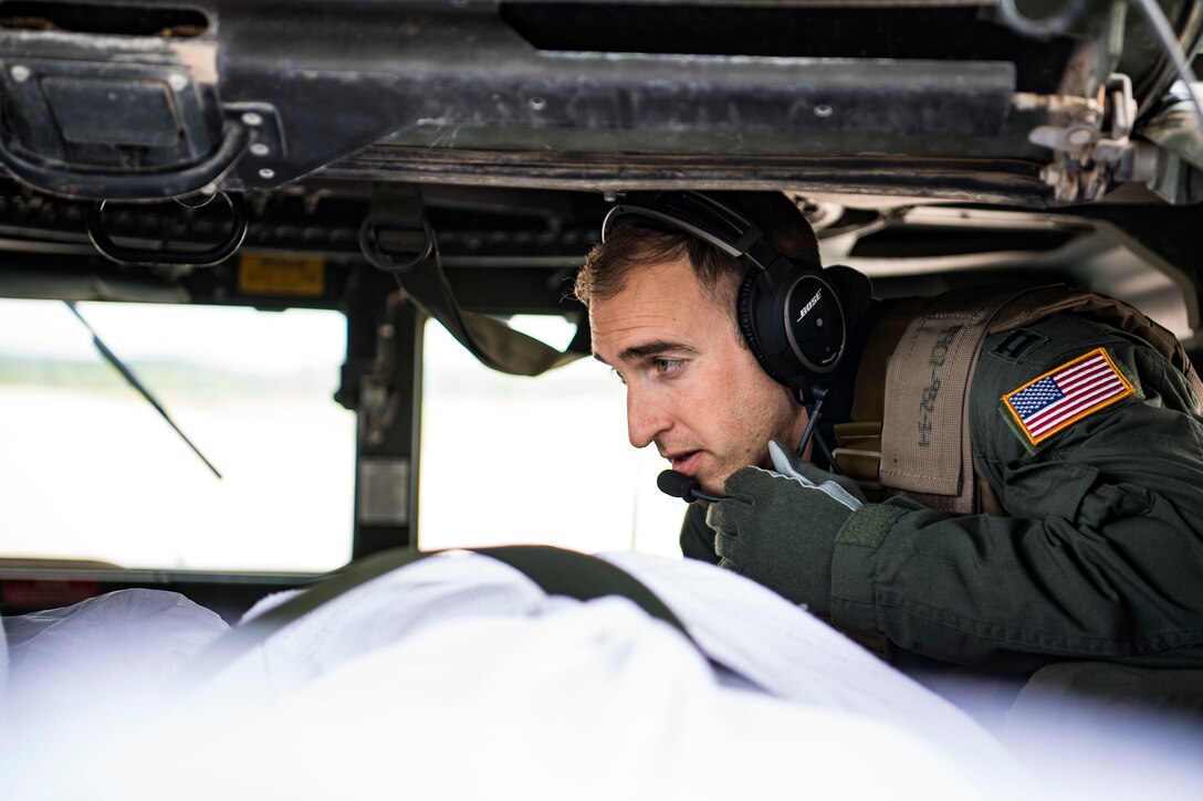 U.S. Air Force Capt. Tyler Relph, critical care aerial transport team registered nurse, manages patient movement during a training scenario as part of the Patriot Warrior exercise Aug. 16, 2019, at Fort McCoy, Wis. Patriot Warrior is Air Force Reserve Command's premier exercise providing Airmen an opportunity to train with joint and international partners in airlift, aeromedical evacuation, and mobility support. The exercise builds on our capabilities for the future fight, increasing the readiness, lethality and agility of the Air Force Reserve. (U.S. Air Force Photo by Tech. Sgt. Gregory Brook)