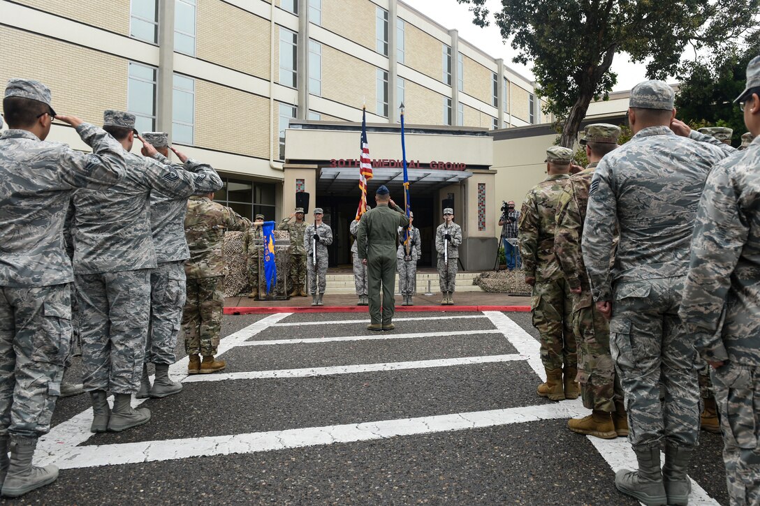 Airmen assigned to the 30th Medical Group salute during the 30th MDG reorganization ceremony Aug. 23, 2019, at Vandenberg Air Force Base, Calif.