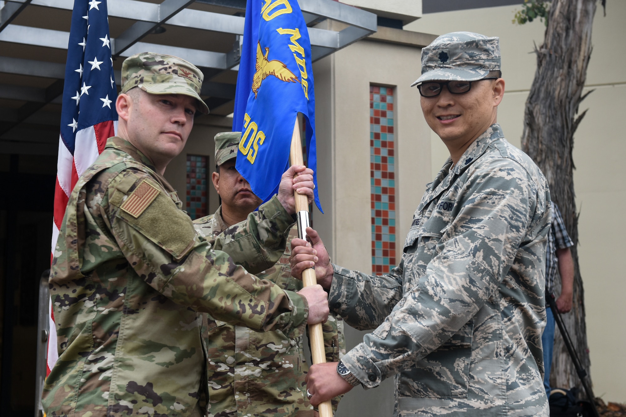 Col. Raymond Clydesdale, 30th Medical Group commander, transfers command of the newly activated 30th Health Care Operations Squadron to Lt. Col. Joseph Rountree, 30th HCOS commander, during the 30th MDG reorganization ceremony Aug. 23, 2019, at Vandenberg Air Force Base, Calif.