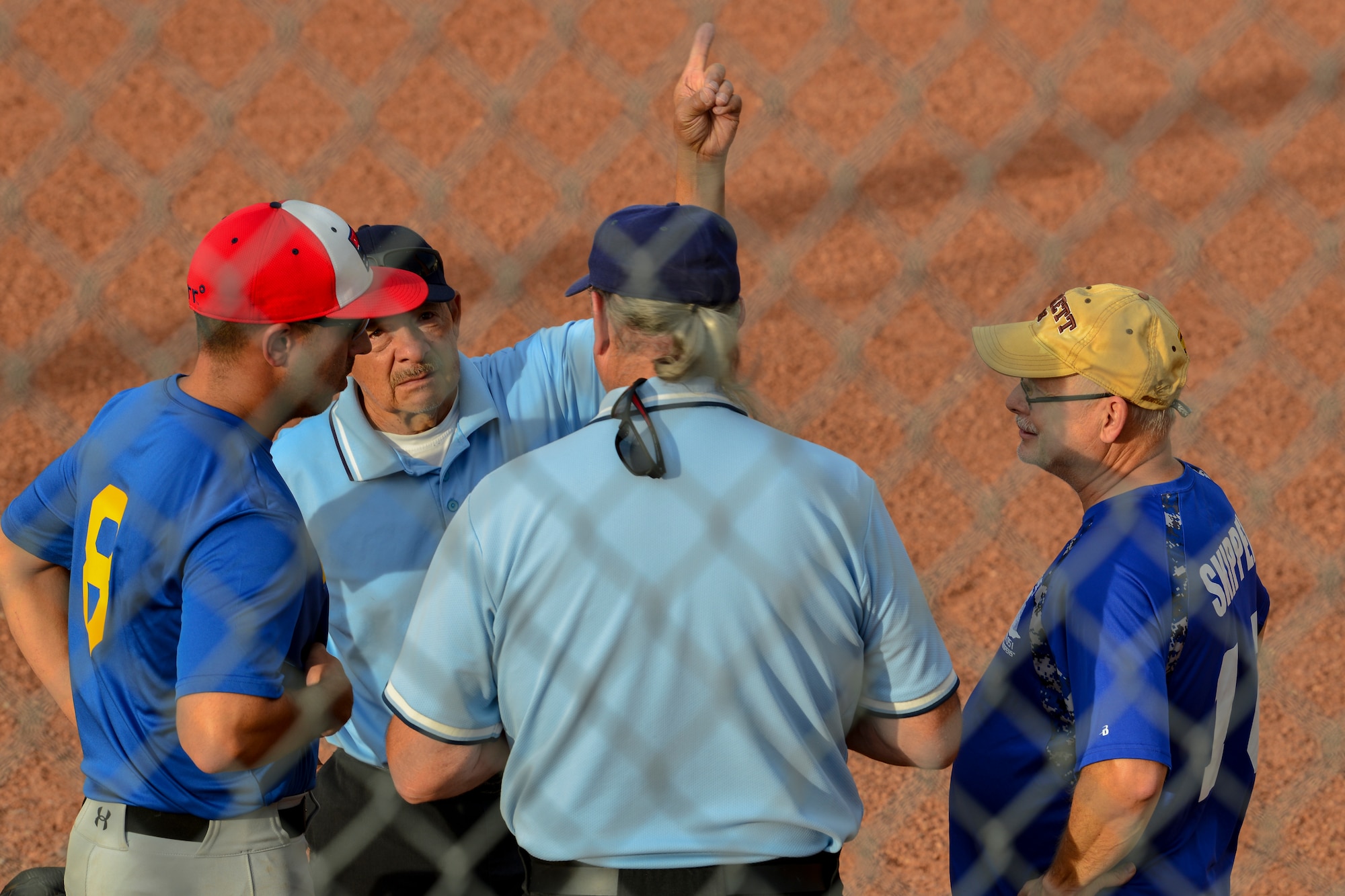 Softball captains from Team AFRL and Team SFS meet with umpires before the 2019 Kirtland Softball Intramural Championship Game at Kirtland Air Force Base, N.M., August 22, 2019. The championship game was a seven-inning game with Team AFRL beating Team SFS with a final score of 26-22. (U.S. Air Force photo by Airman 1st Class Austin J. Prisbrey)