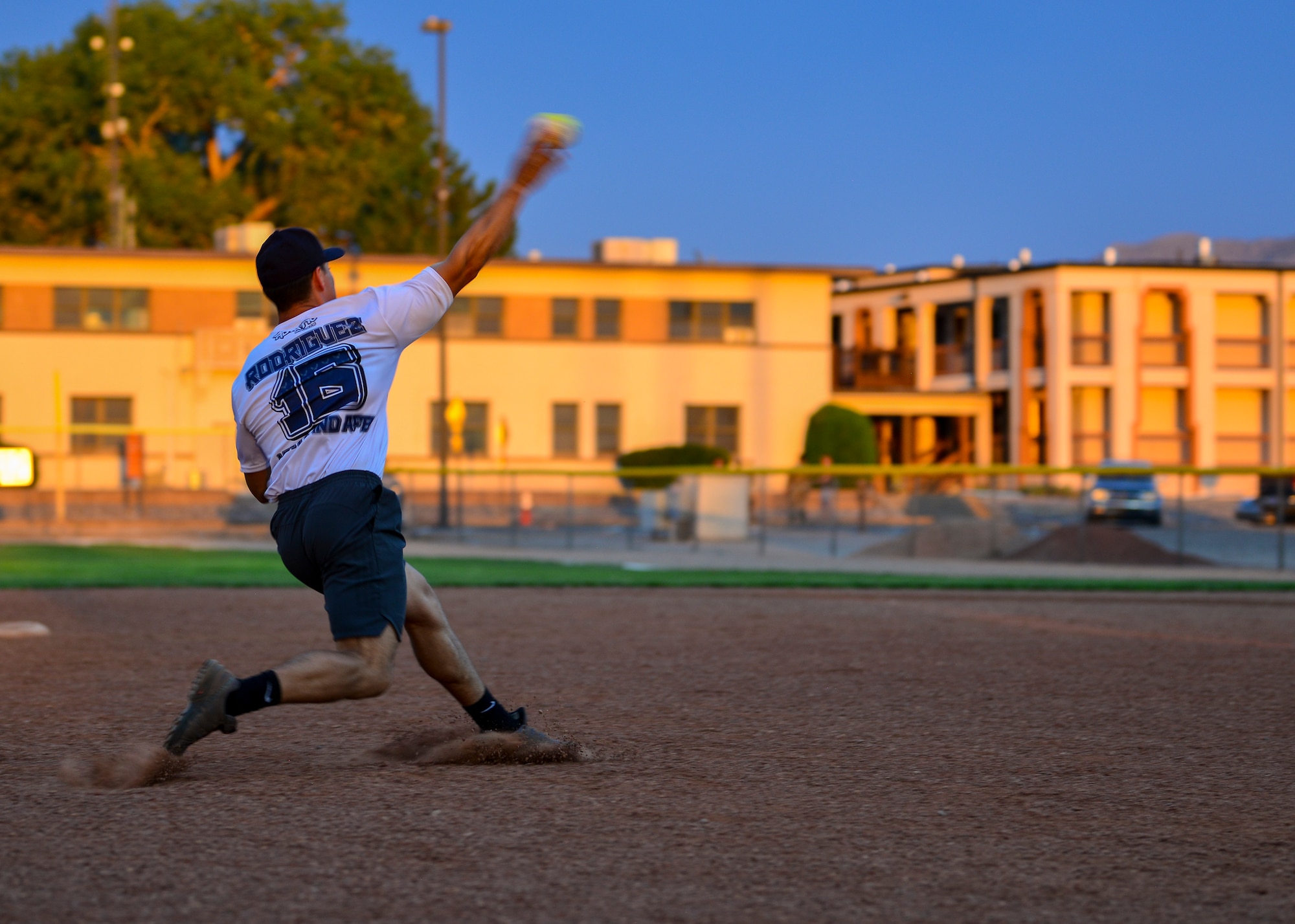 Gabe Rodriguez, third baseman for Team SFS, throws the softball to first base during the 2019 Kirtland Softball Intramural Championship Game at Kirtland Air Force Base, N.M., August 22, 2019. The championship game was a seven-inning game with Team AFRL beating Team SFS with a final score of 26-22. (U.S. Air Force photo by Airman 1st Class Austin J. Prisbrey)