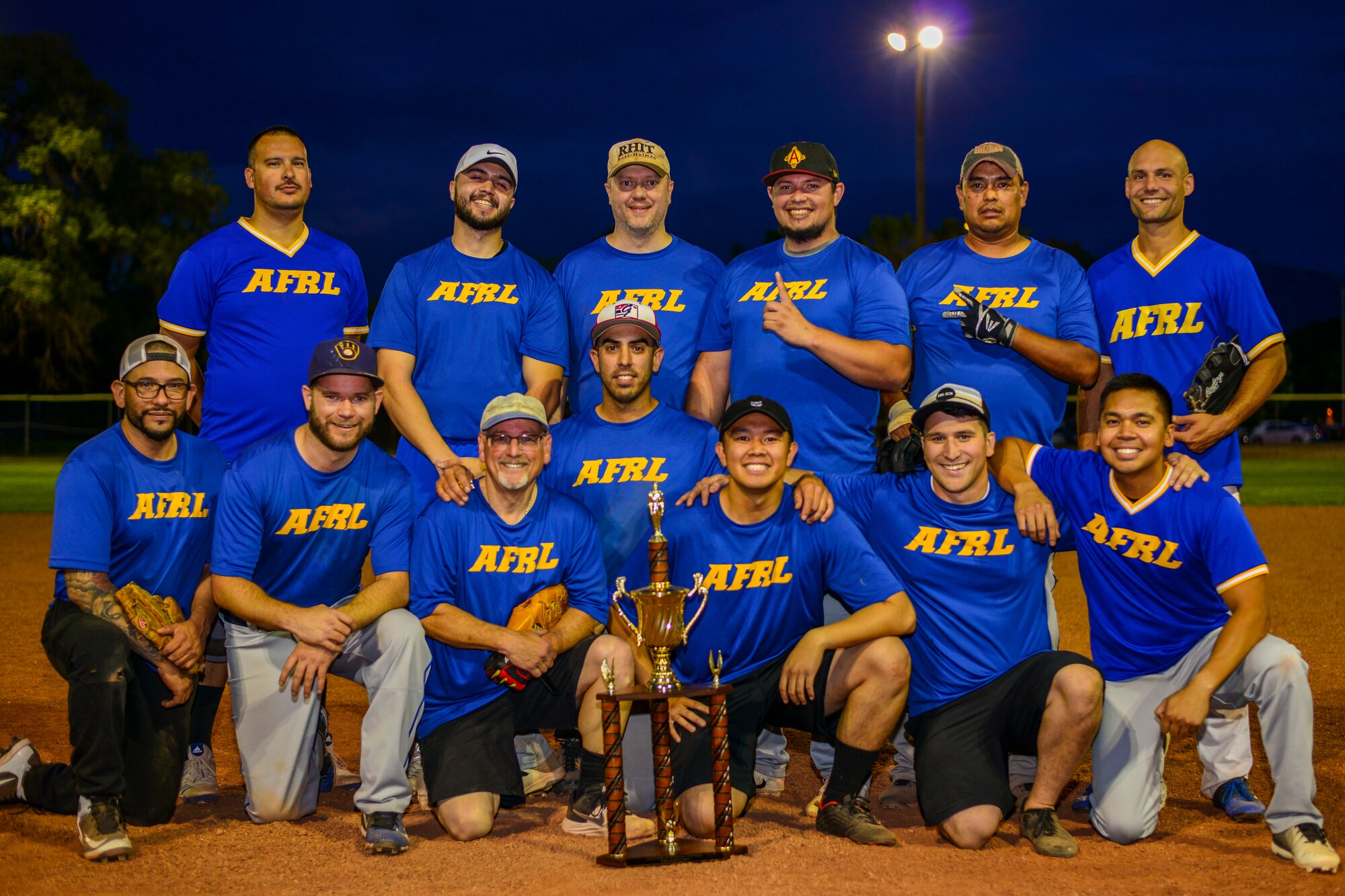 Team AFRL poses for a photo with the 2019 Kirtland Softball Intramural Championship trophy at Kirtland Air Force Base, N.M., August 22, 2019. Team AFRL beat Team SFS for the championship game with a final score of 26-22. (U.S. Air Force photo by Airman 1st Class Austin J. Prisbrey)